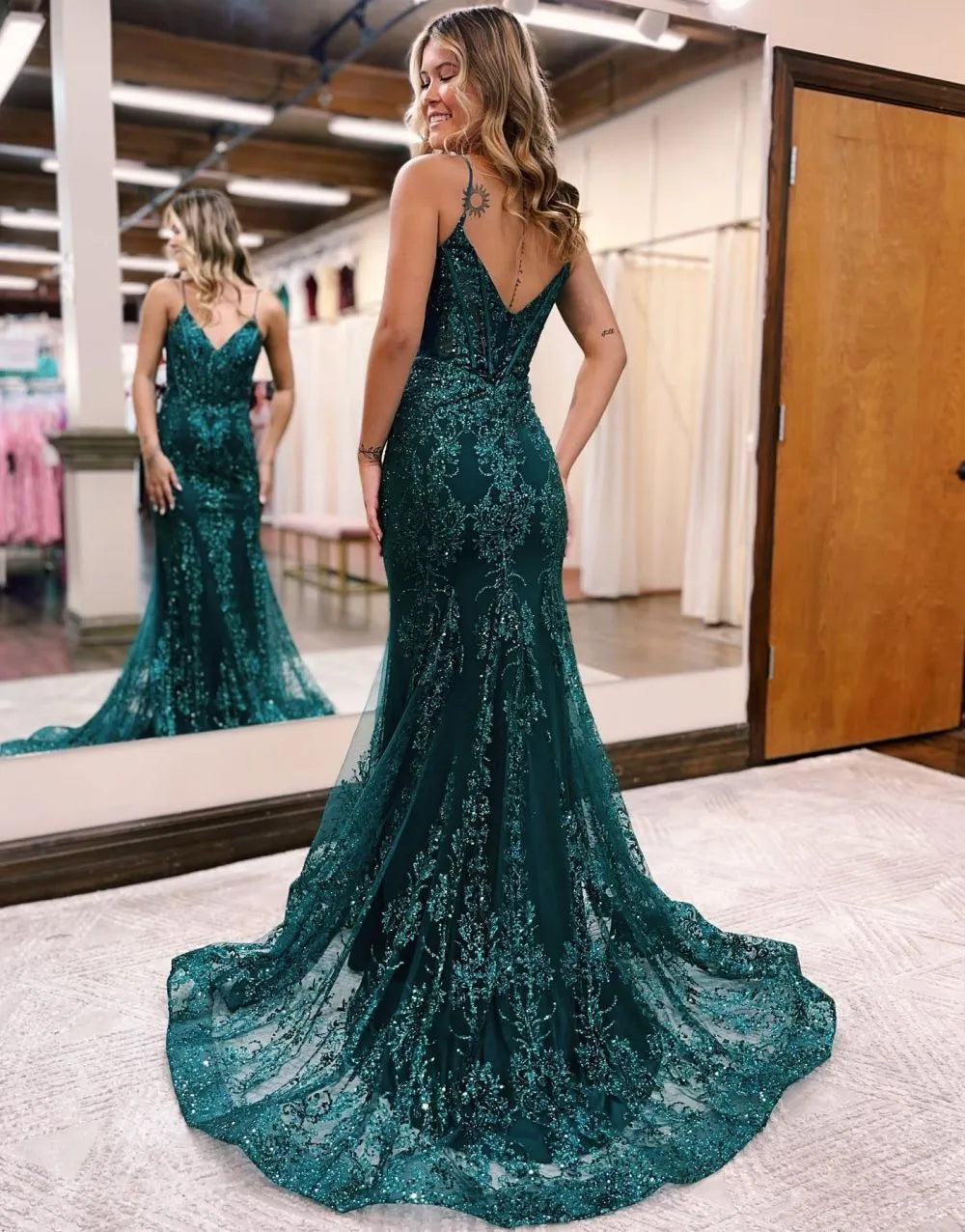 Close-up of appliques on the peacock blue spaghetti strap mermaid dress.