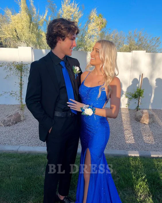 Back view of a woman in a blue mermaid formal dress, highlighting the backless design.