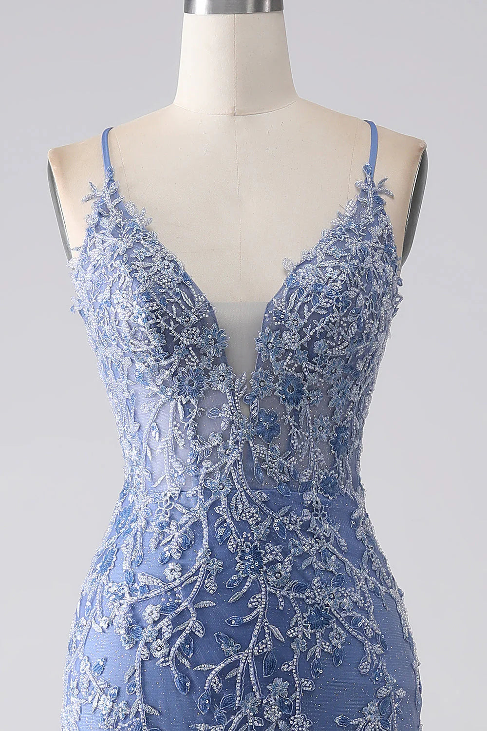 Close-up detail of the intricate appliques and beading on the grey-blue mermaid dress.