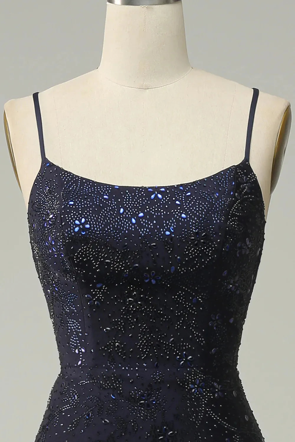 Back view of elegant navy mermaid dress with delicate straps.