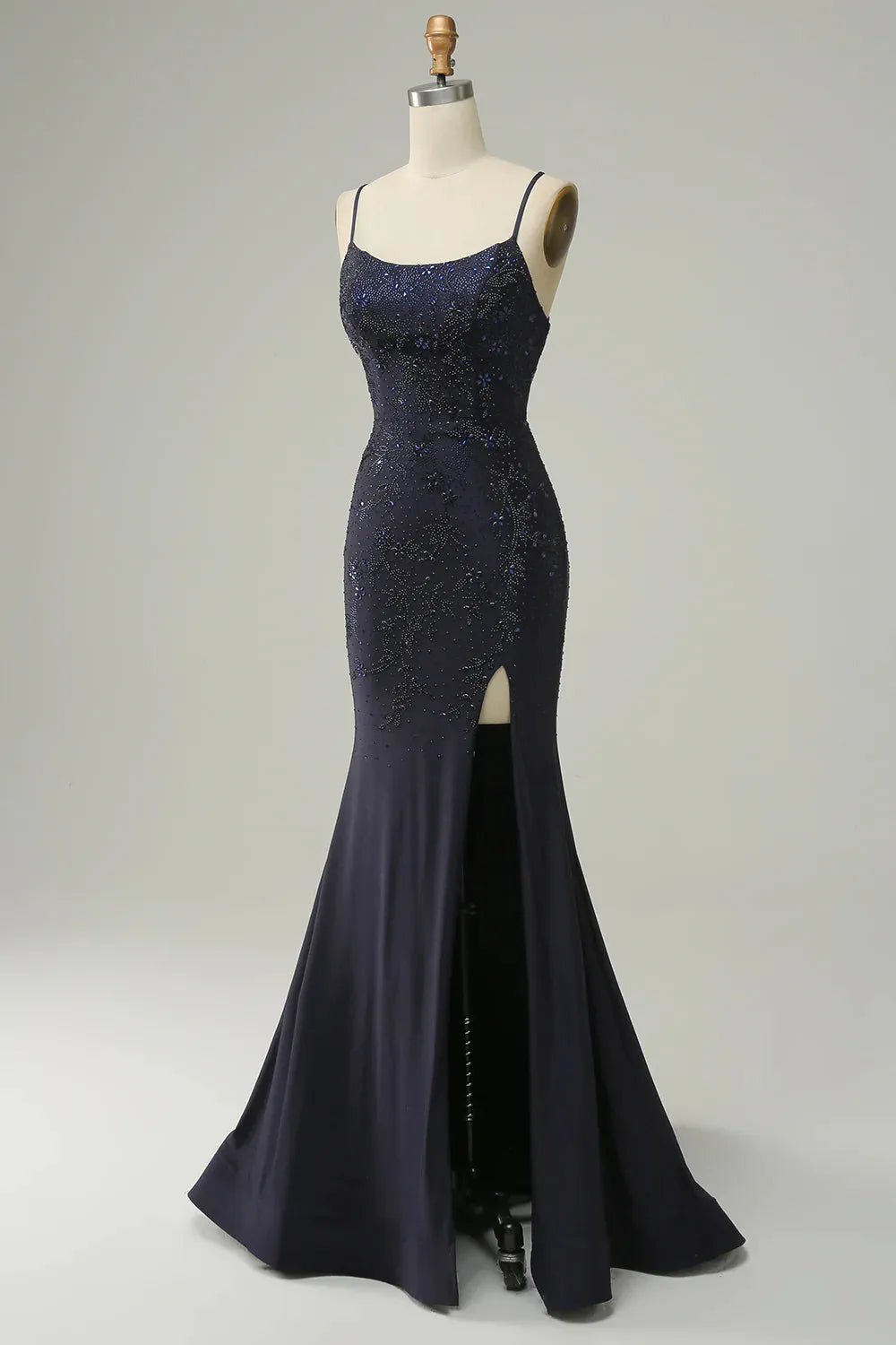 Close-up of beaded detailing on navy mermaid prom dress.