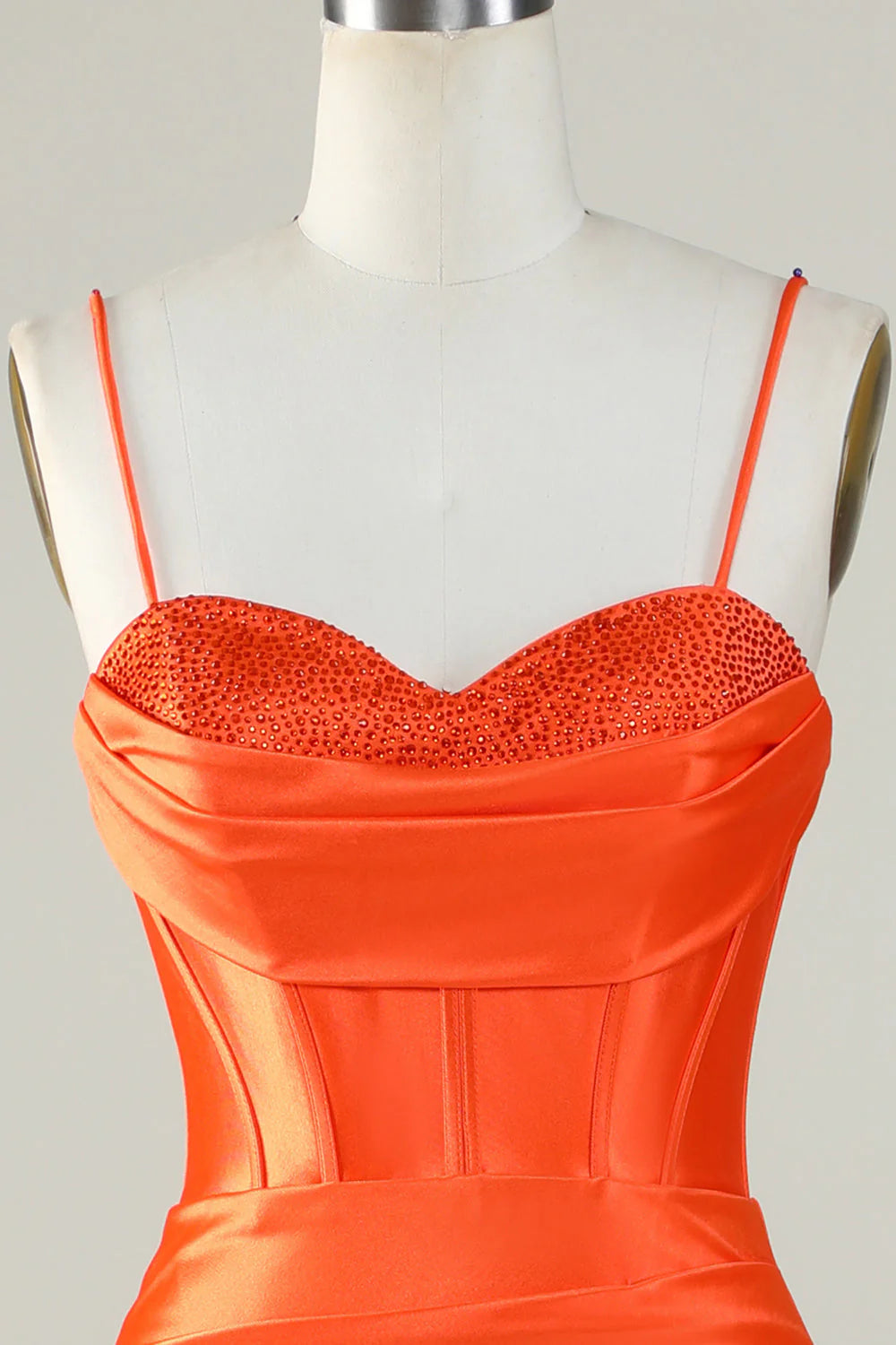 Back view of an orange spaghetti strap mermaid dress.