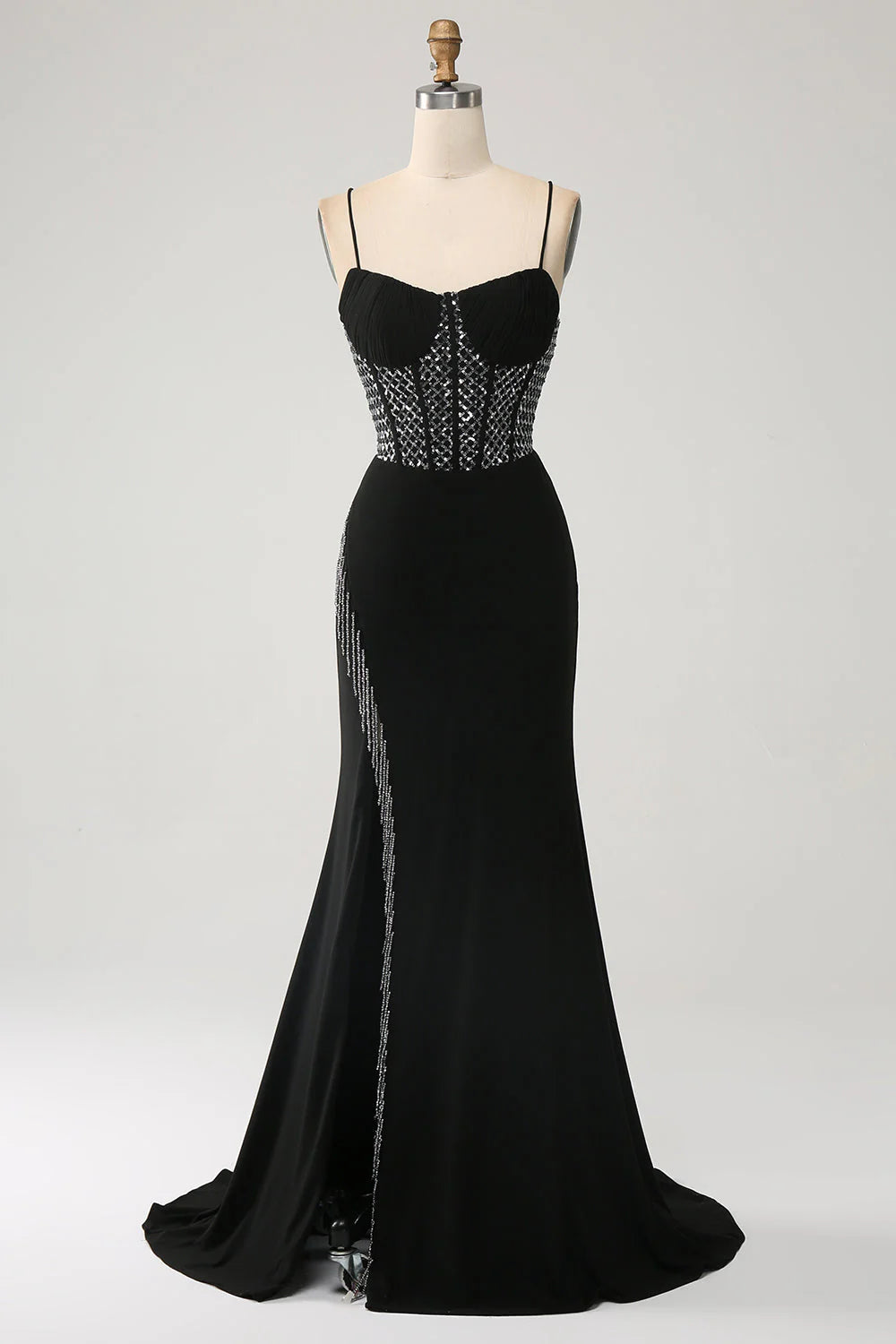Black mermaid prom dress with spaghetti straps and a high slit.