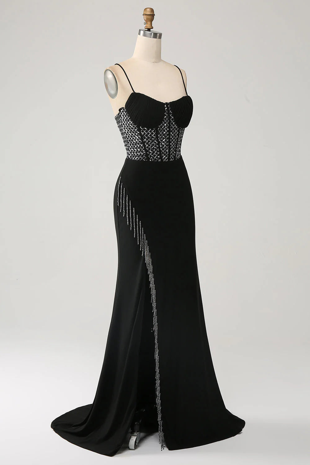 Side view of the black mermaid gown with a flowing skirt.