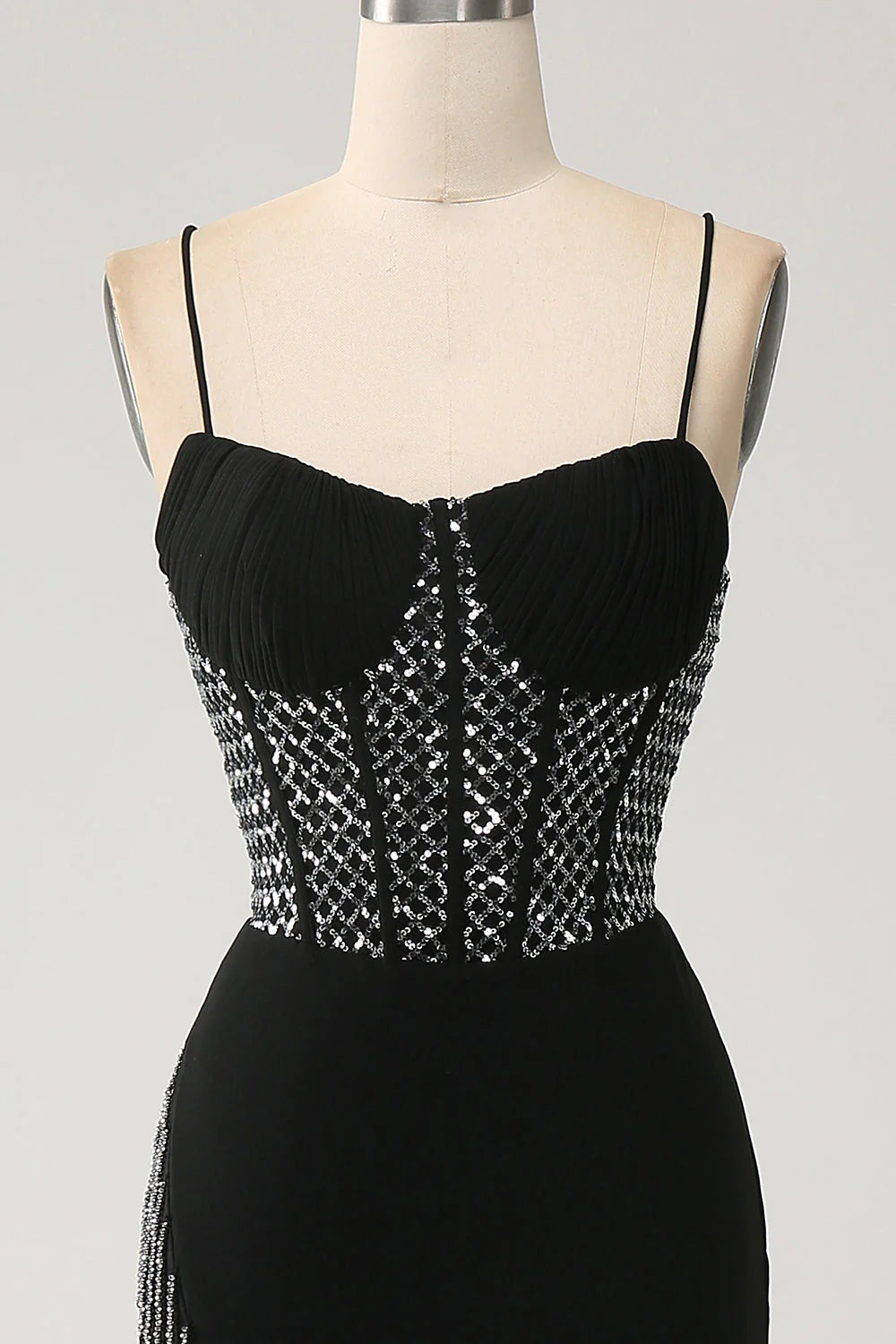 Close-up of the black prom dress bodice with spaghetti straps.