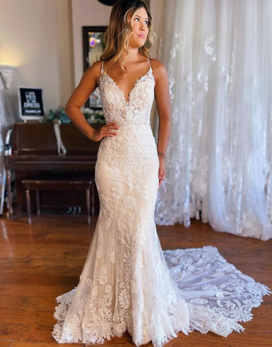 Mermaid wedding dress with spaghetti straps and keyhole back.