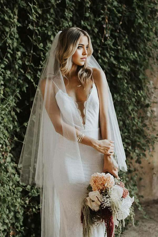 Elegant mermaid lace wedding dress with spaghetti straps.