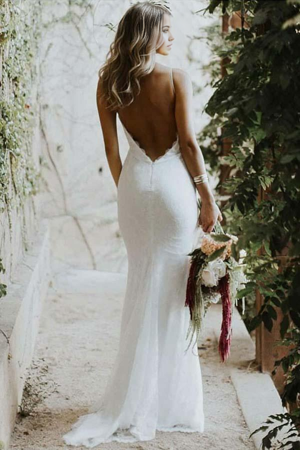 Close-up of lace detail and spaghetti straps on a wedding dress.