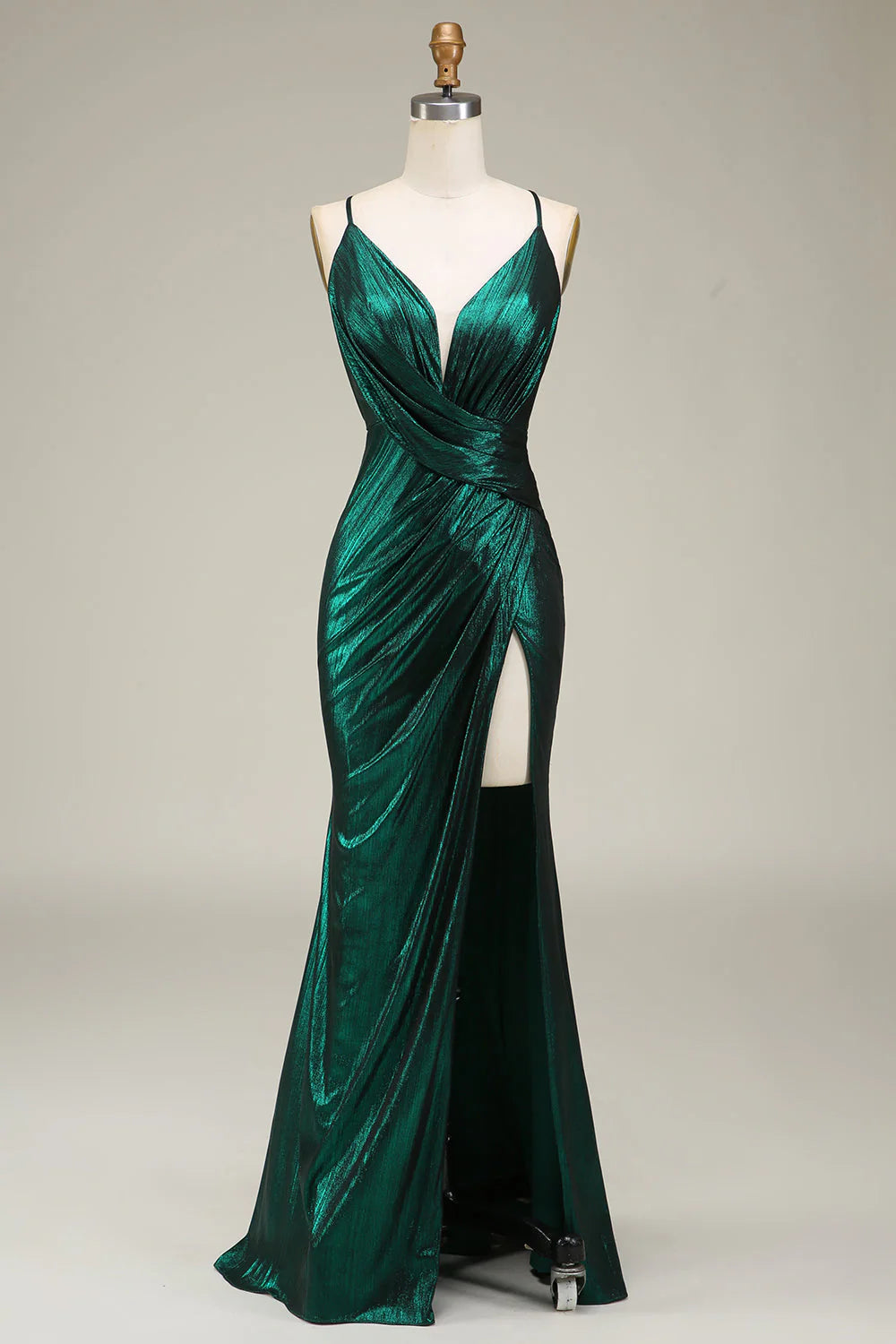 Dark green mermaid prom dress with spaghetti straps and open back.