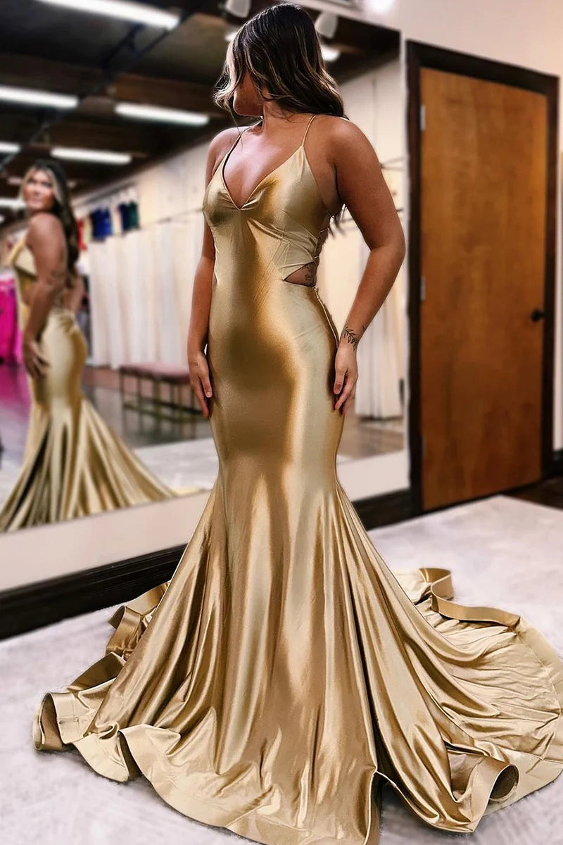 Woman wearing an elegant mermaid trumpet gown with spaghetti straps and a V-neckline.