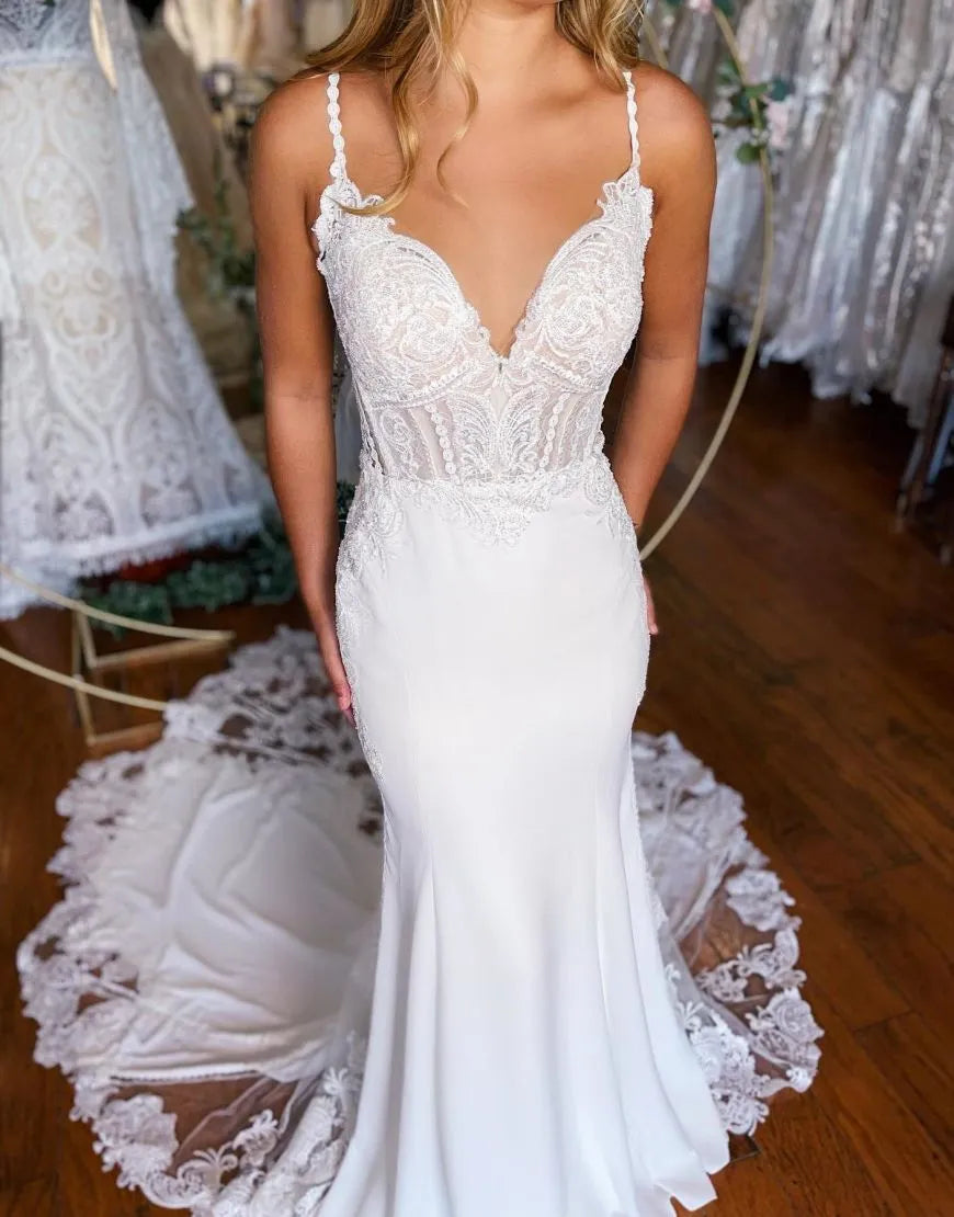 Satin mermaid bridal dress featuring delicate spaghetti straps and floral appliques.