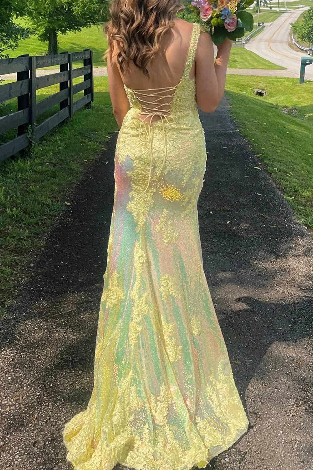 Side view of mermaid prom dress showing thigh split detail.