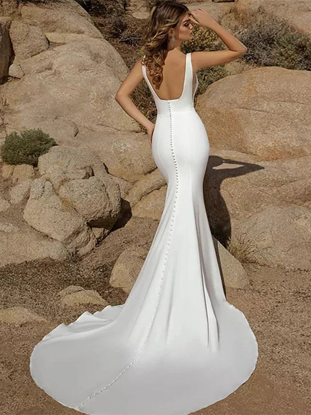 Back view of a mermaid wedding dress showing button details and court train.