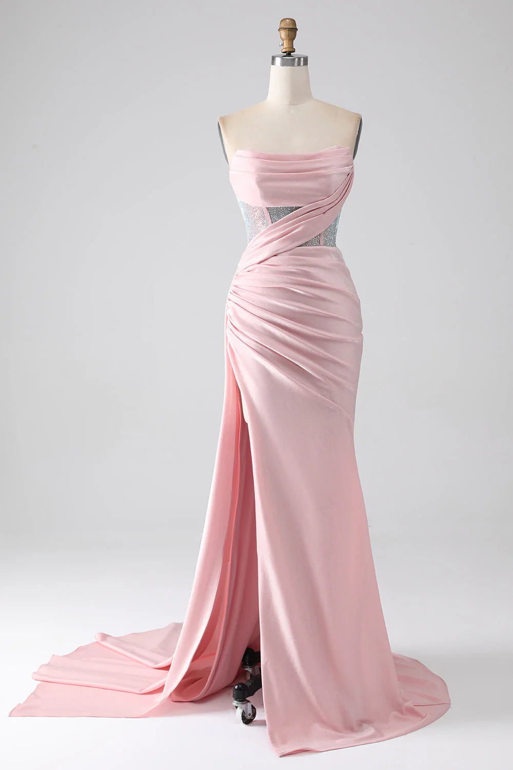 Pink mermaid strapless prom dress with intricate beading and pleats.