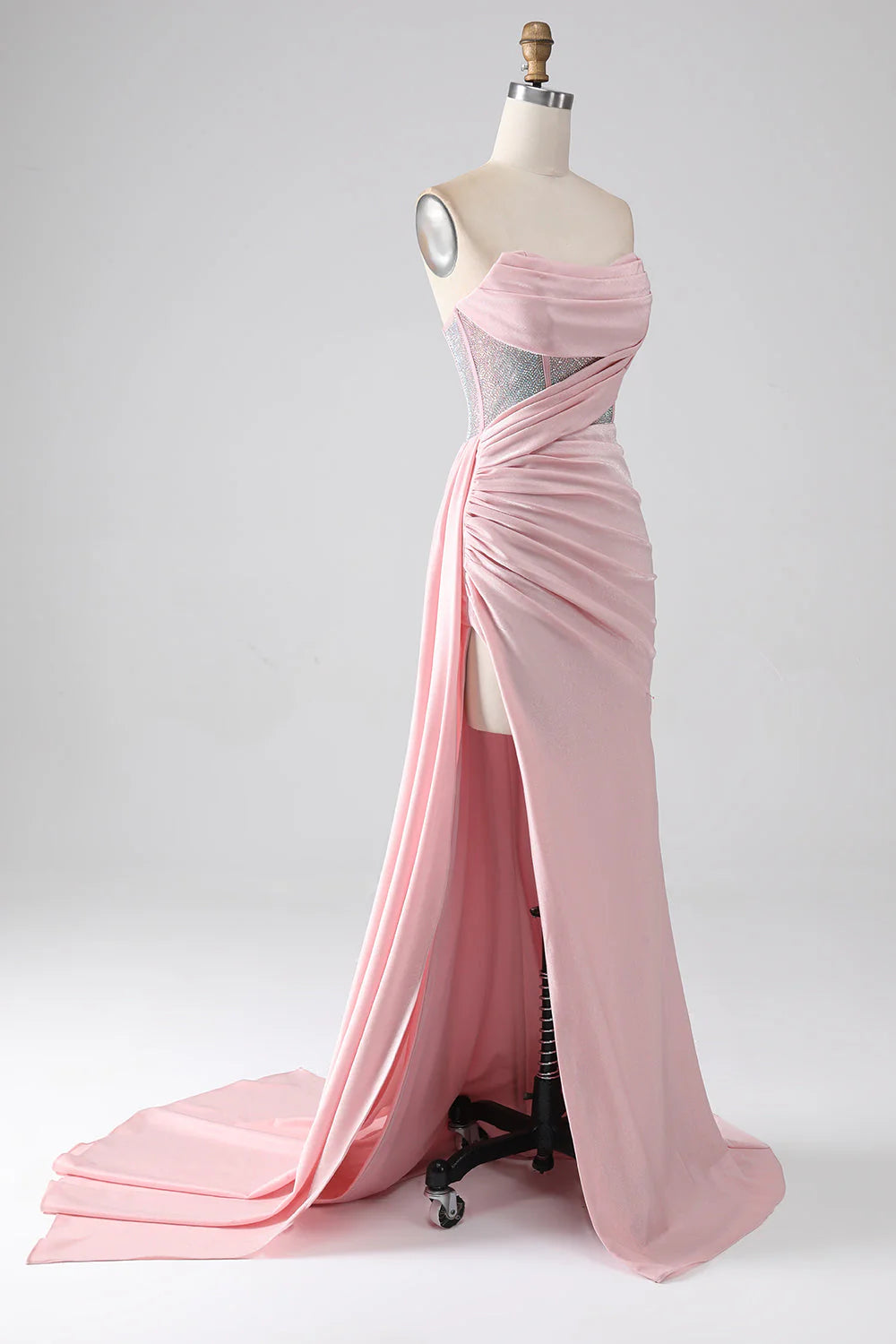 Side profile of a pink formal dress, showing the high slit and mermaid silhouette.
