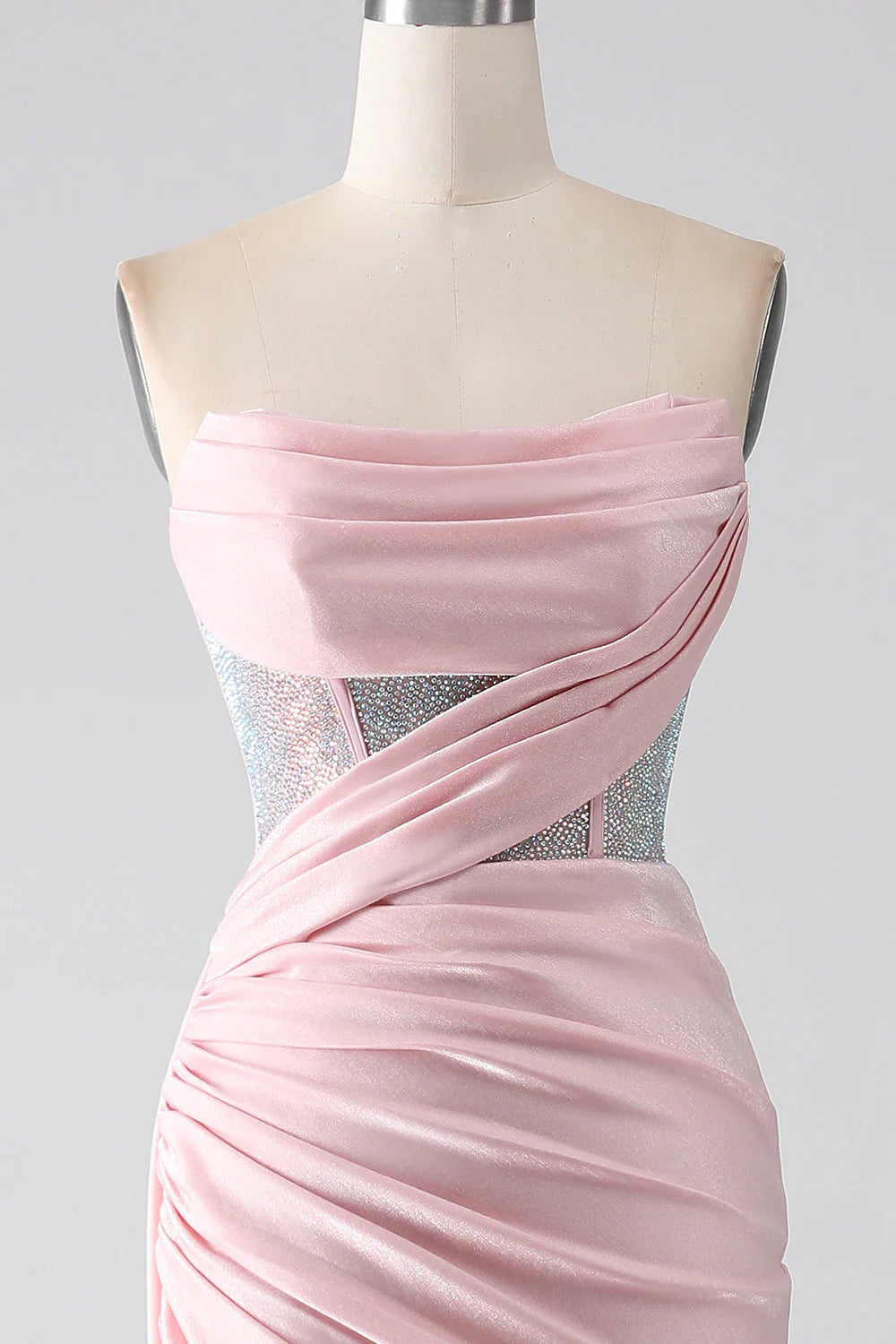 Close-up of the beaded bodice and pleated details on a pink strapless dress.