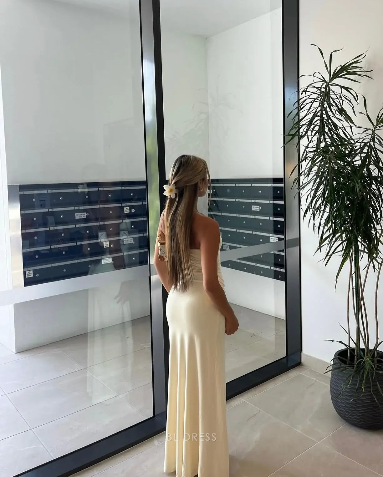 Side view of a strapless mermaid chiffon evening gown.