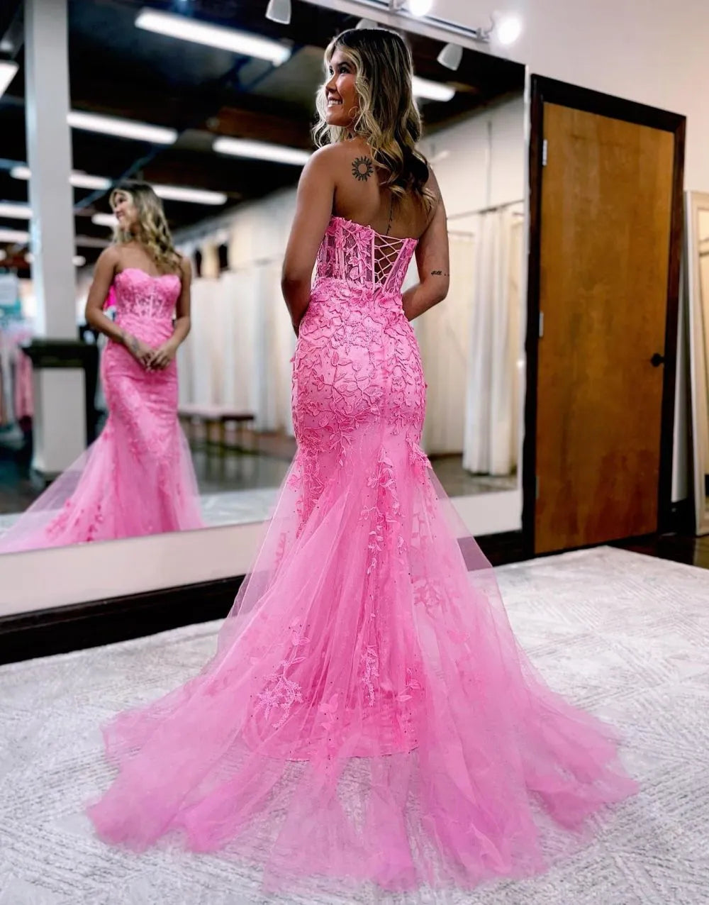 Back view of a strapless mermaid formal gown with corset detailing.