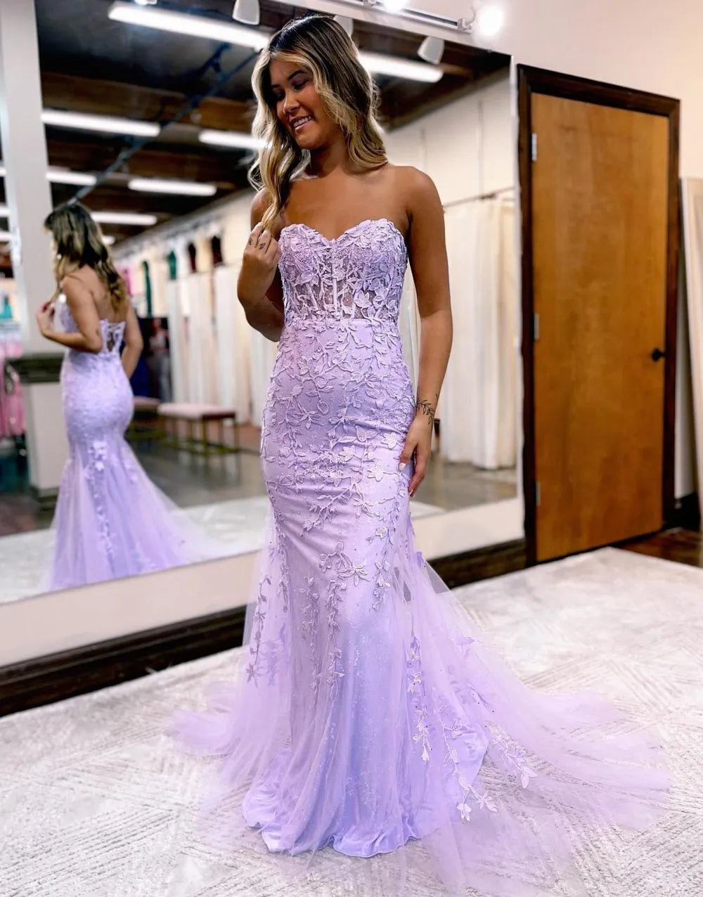 Close-up of the corset bodice and appliques on a strapless mermaid gown.