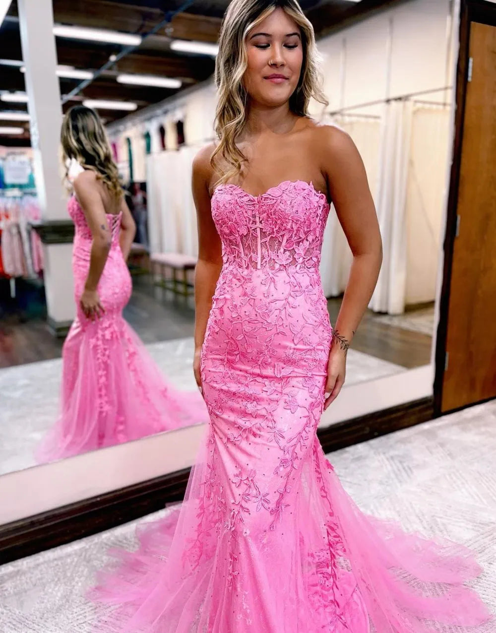 Elegant mermaid strapless prom dress with appliques, front view.