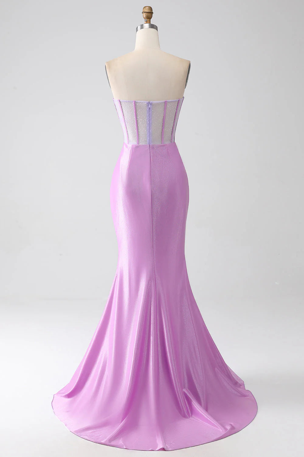 Back view of a woman wearing a lilac mermaid prom dress.
