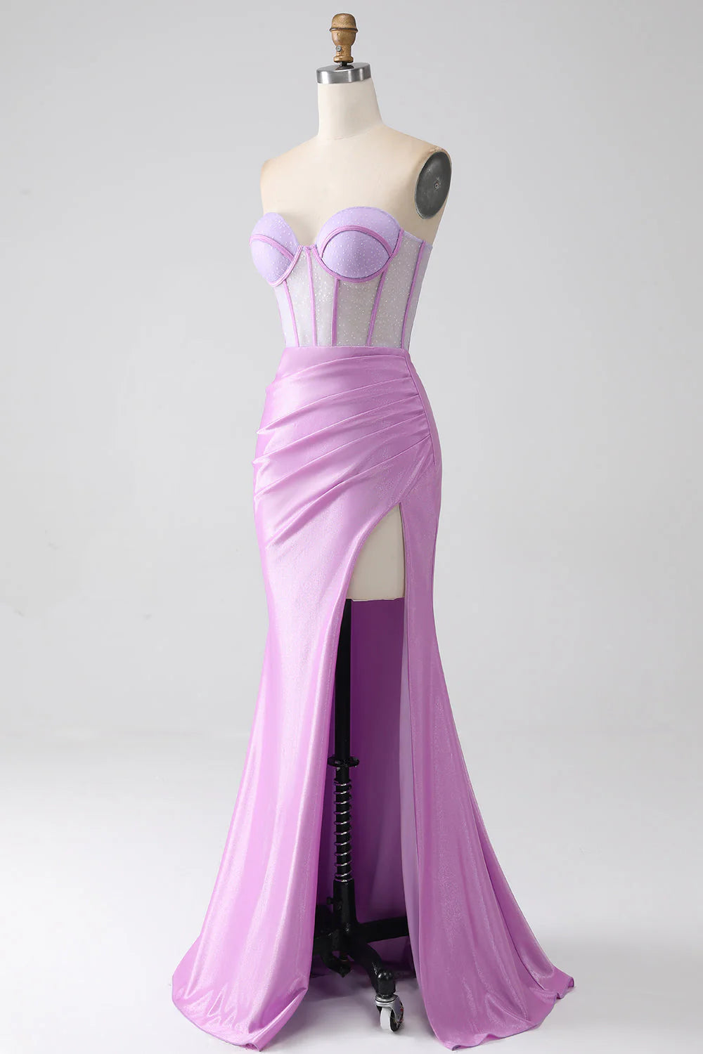 Side view of a woman in a lilac strapless formal gown.