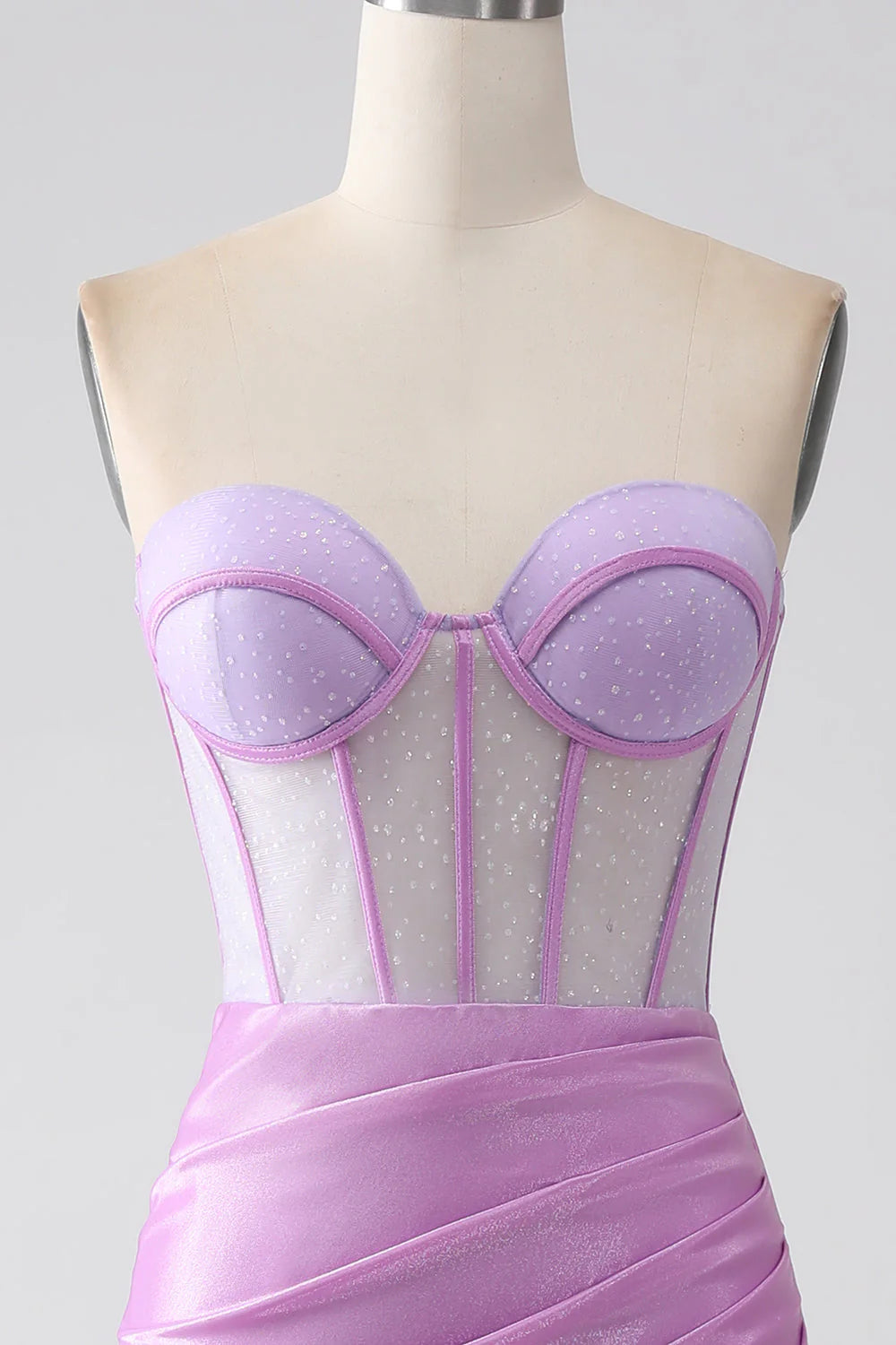 Close-up of the corset bodice and slit on a lilac prom dress.