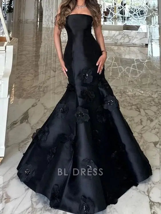Elegant black mermaid strapless gown with floral details, full length view.