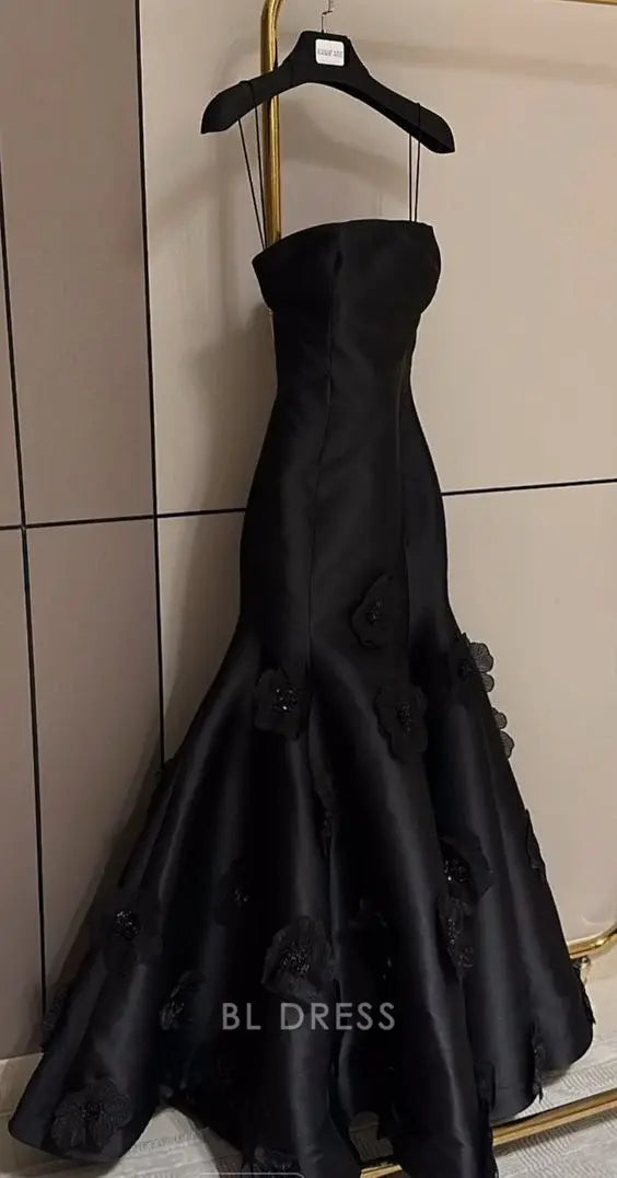 Close-up of the black mermaid strapless floral evening gown.