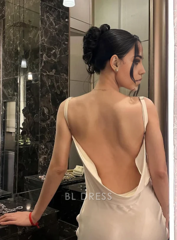 Back view of a white mermaid evening gown featuring intricate floral details.