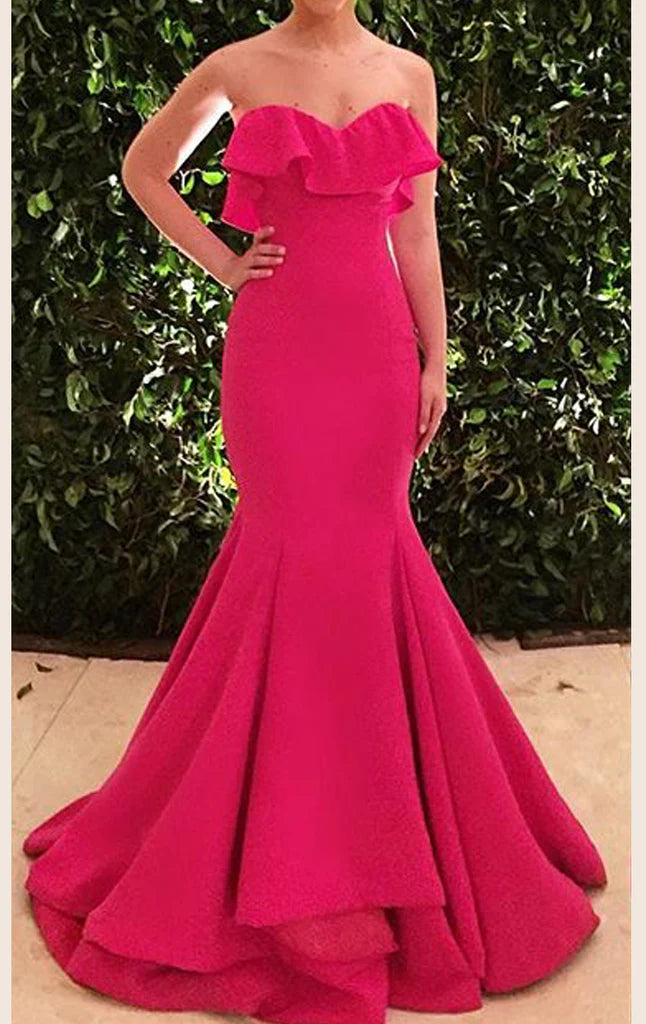 Woman wearing an elegant mermaid strapless long prom dress.