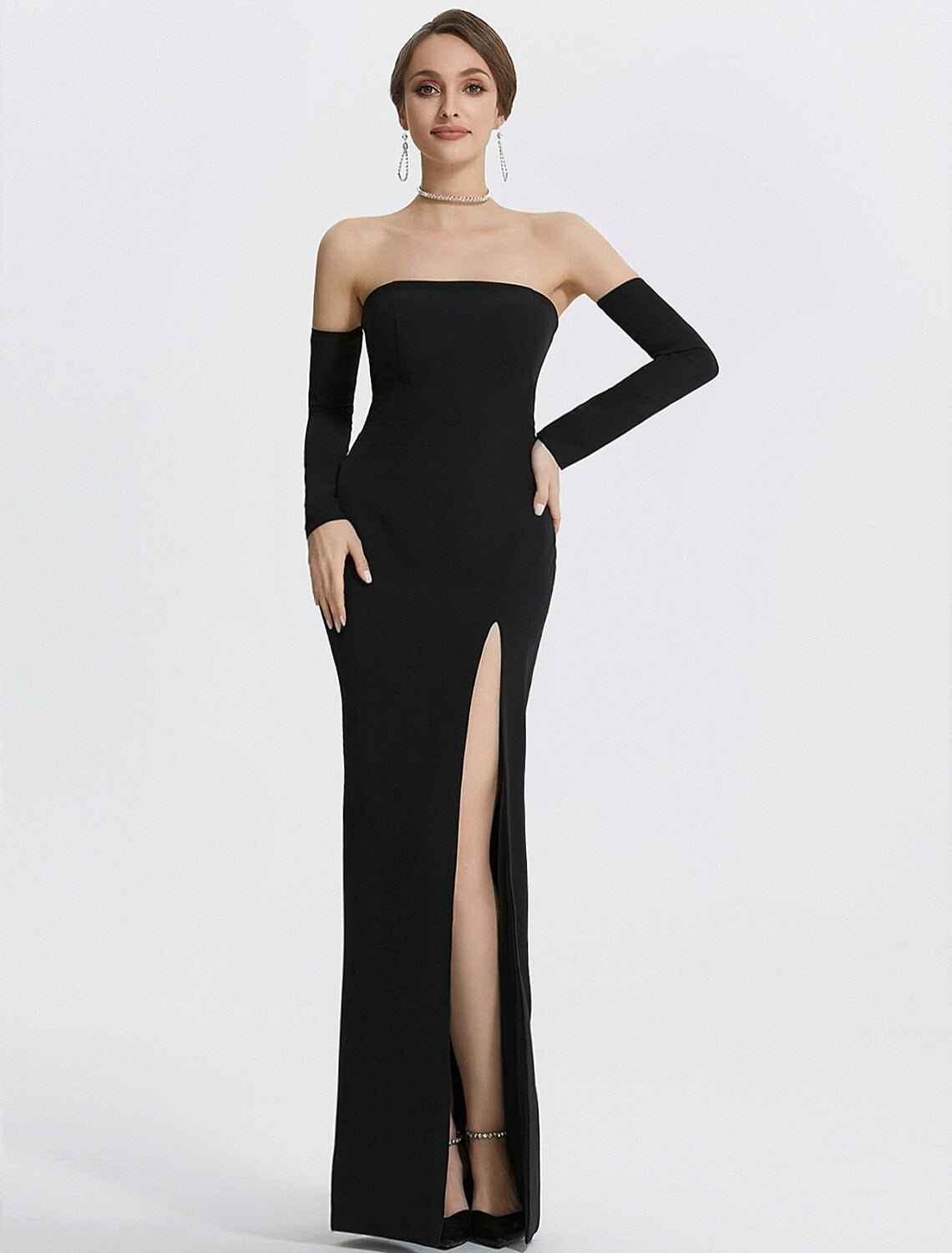 Black mermaid evening gown with a high slit and long matching gloves.
