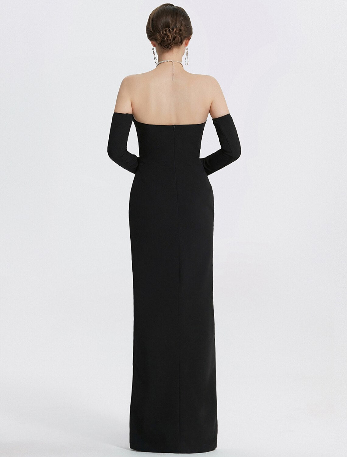 Back view of a black strapless mermaid gown, showing its elegant silhouette.