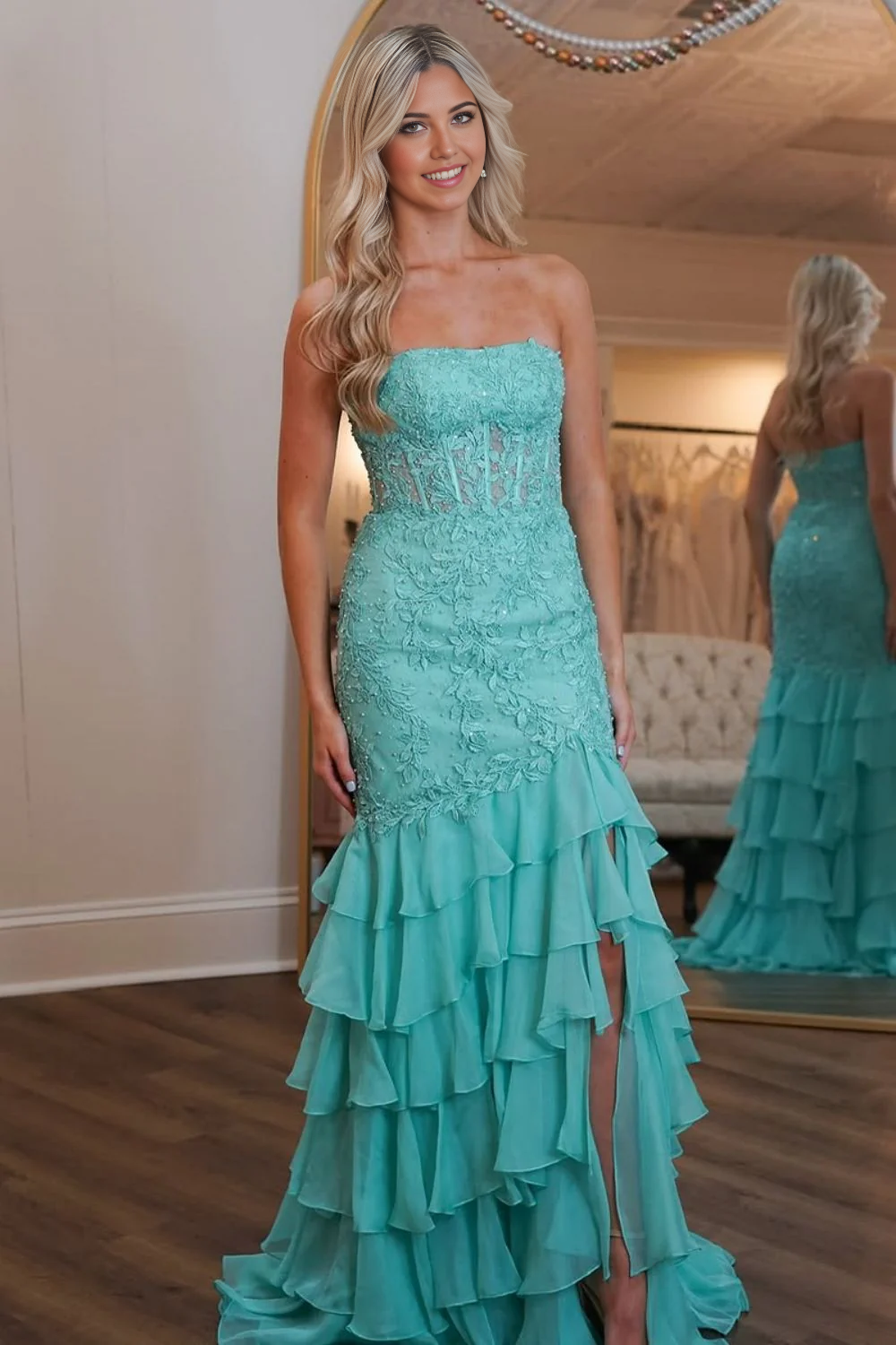 Elegant mint green mermaid prom dress with a strapless lace top and tiered skirt.