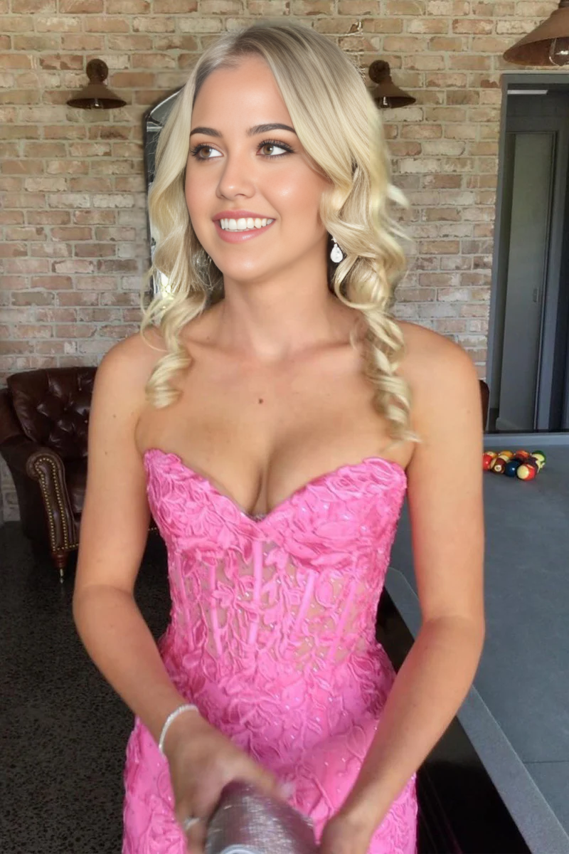 Side profile of a pink strapless mermaid gown with intricate lace details.