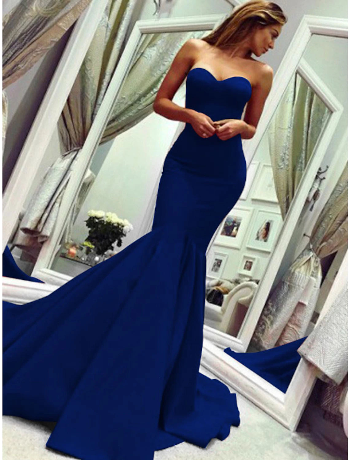 Close-up of the pleated details on the bodice of the strapless mermaid gown.
