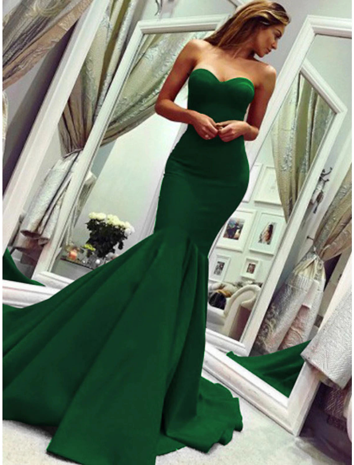 Full-length view of a woman in a strapless mermaid gown, showcasing the overall design.