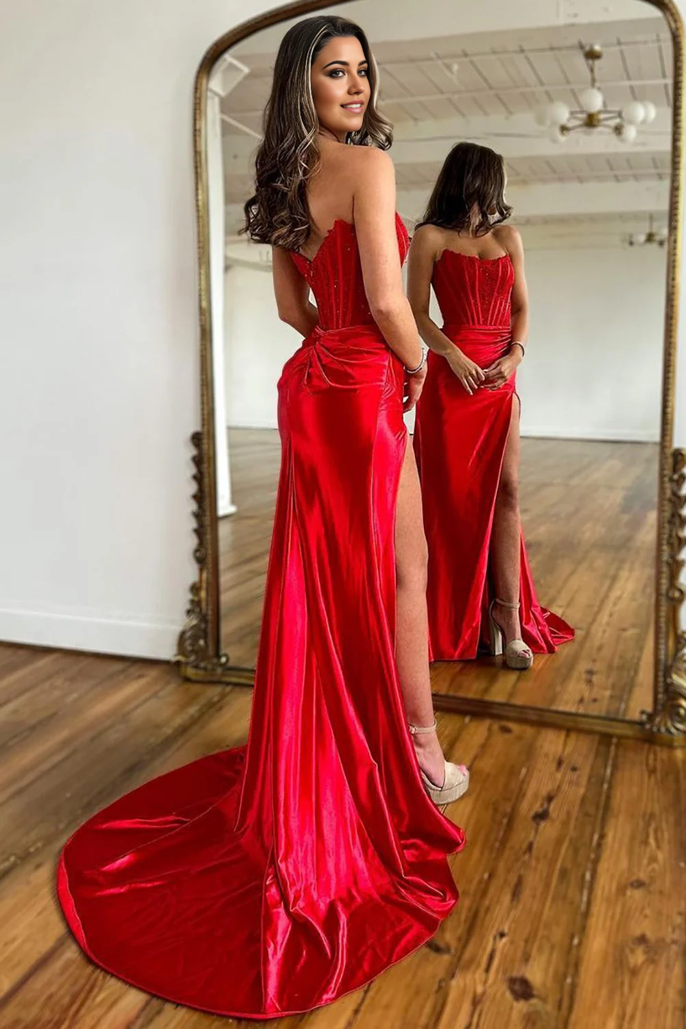 Side view of a Mermaid Strapless Satin Gown, showcasing the sweep train and leg split.
