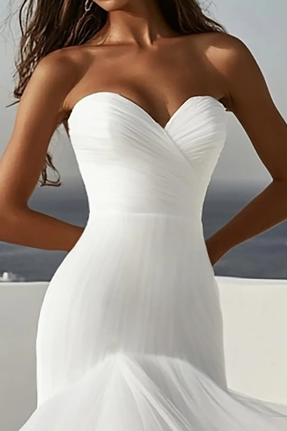 Back view of ivory mermaid wedding dress, showing ruffled train and elegant silhouette.