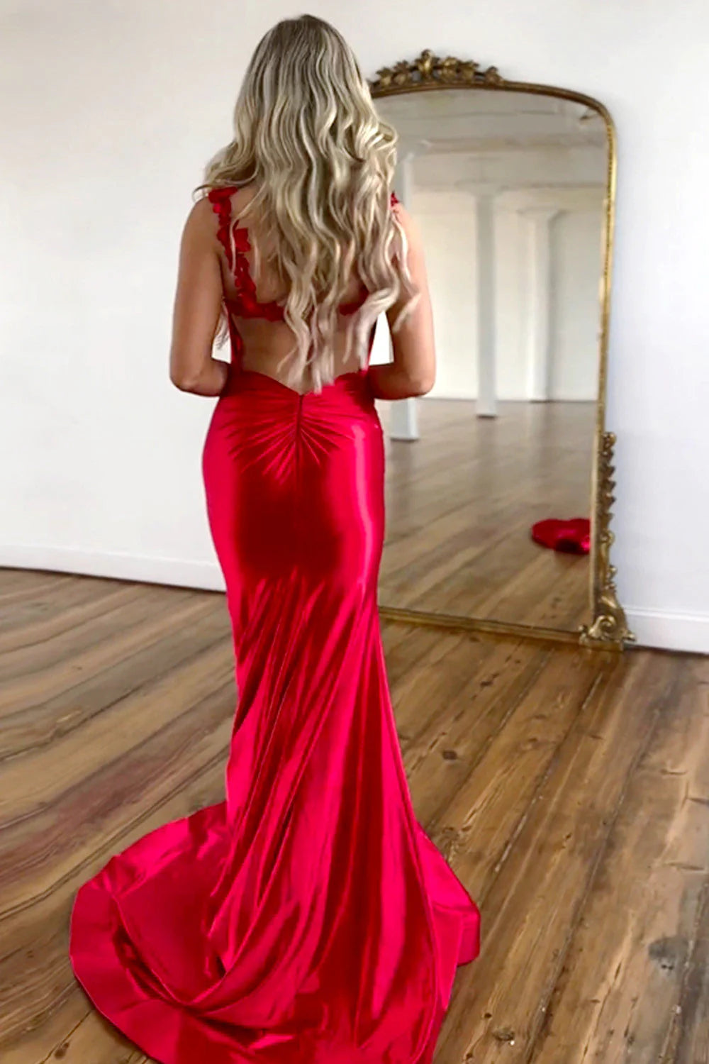 Back view of a red mermaid satin dress, showcasing the elegant strap details.