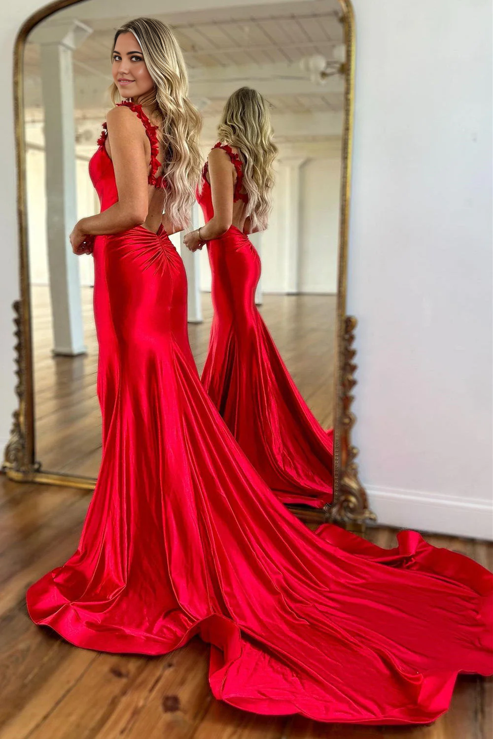 Full-length view of a model wearing a red mermaid satin formal dress.
