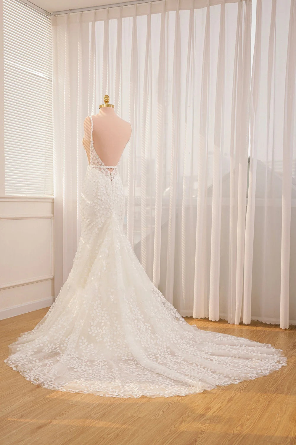 Back view of a mermaid wedding dress showcasing lace and appliques.