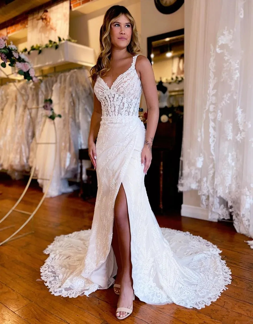 Elegant mermaid wedding dress with lace details and a split skirt.