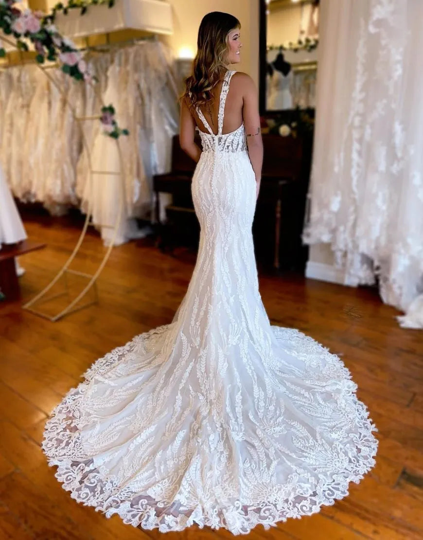 Back view of a mermaid wedding gown featuring a court train and delicate straps.