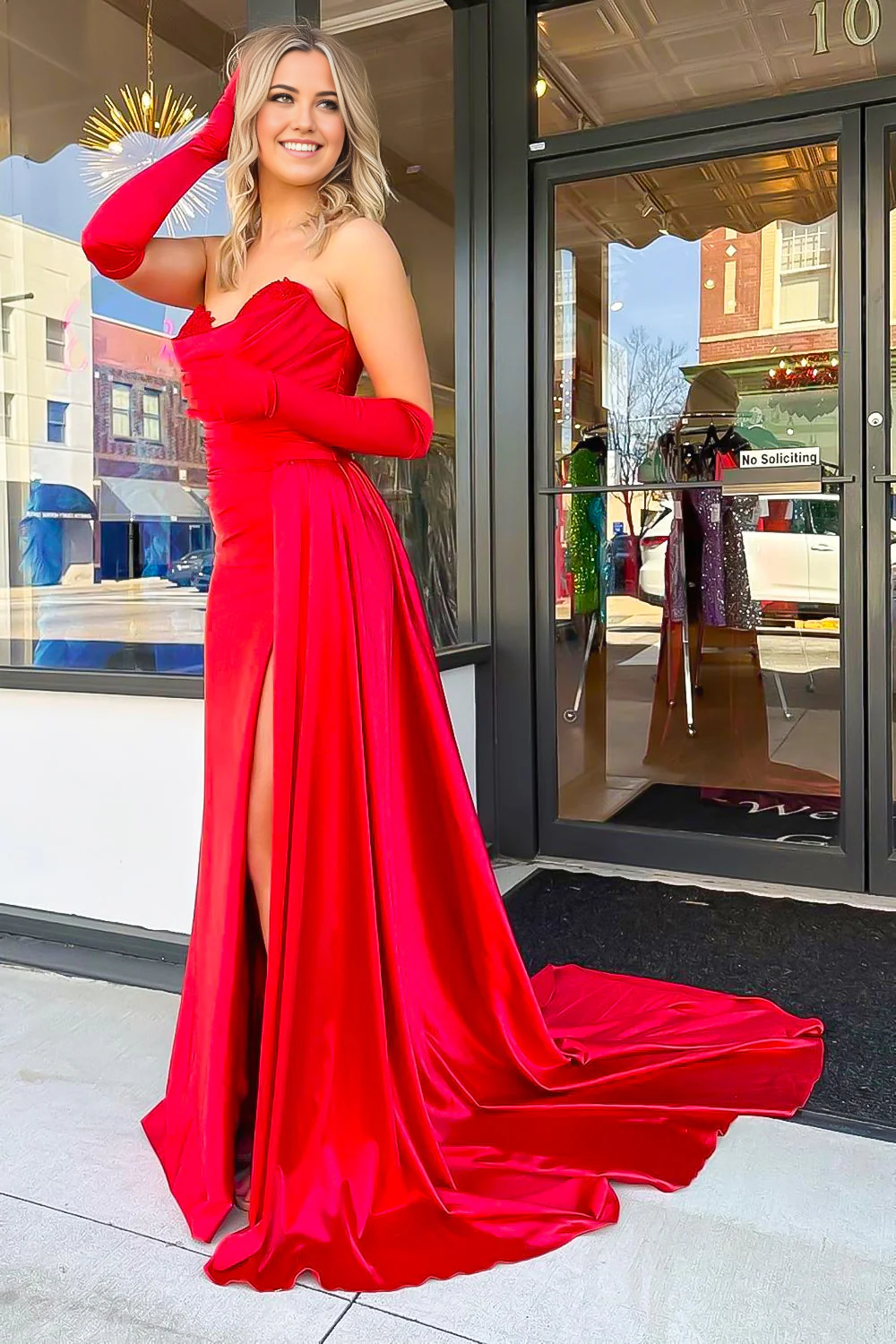 Full length view of a black mermaid prom dress, featuring a sweetheart neckline.