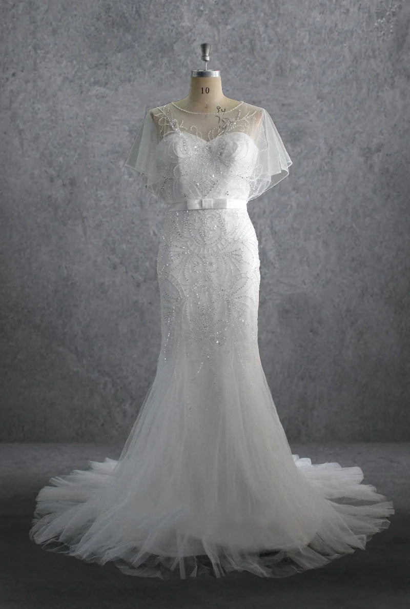 Elegant mermaid wedding dress with sweetheart neckline and intricate beading on tulle fabric.