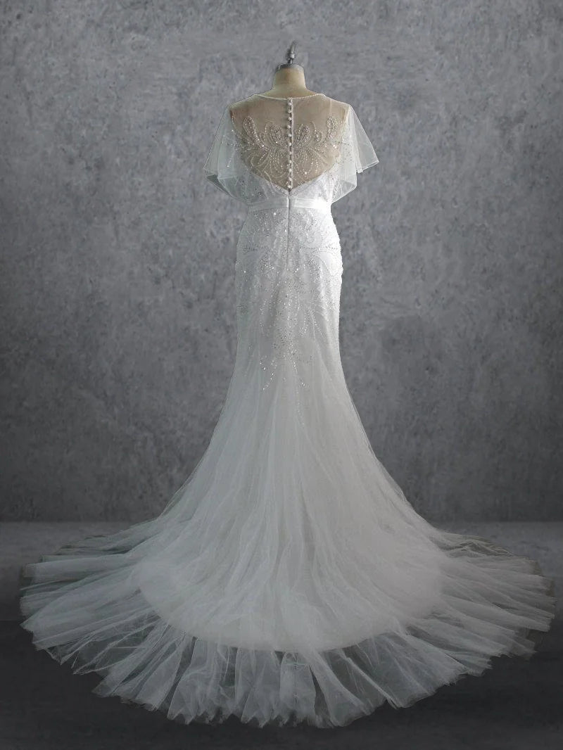 Close-up of the delicate beading and flowing tulle on a mermaid wedding gown.