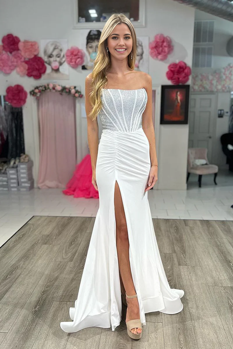 Close-up of the sweetheart neckline and delicate beading on the white satin dress.