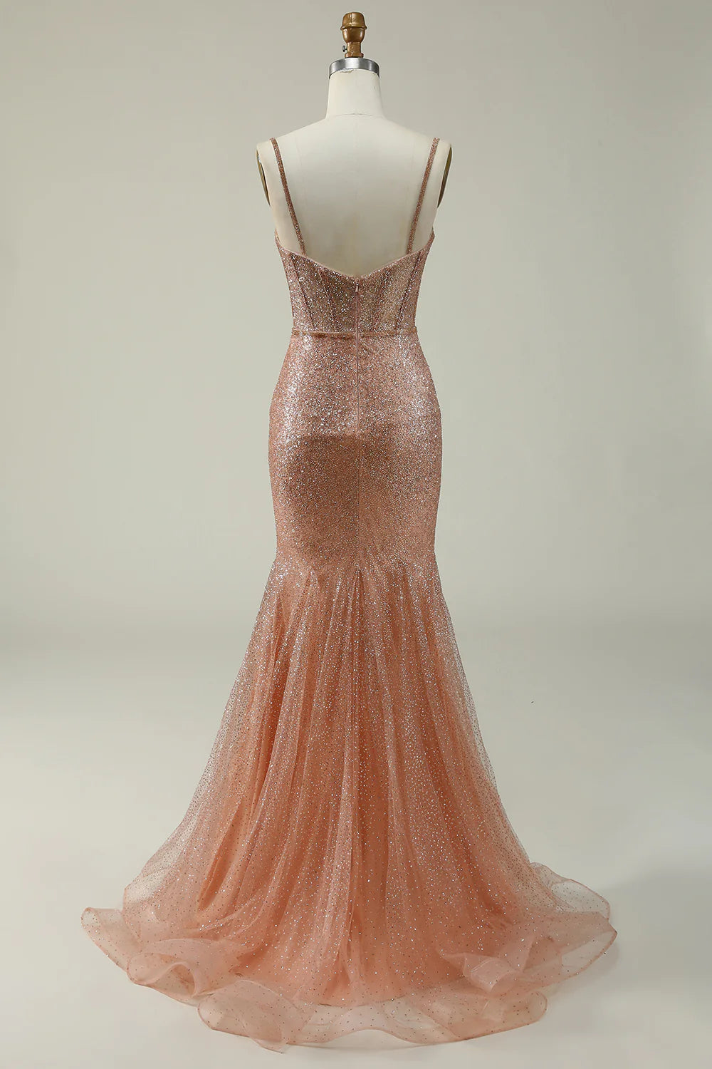 Back view of a blush pink mermaid prom dress with corset detailing.