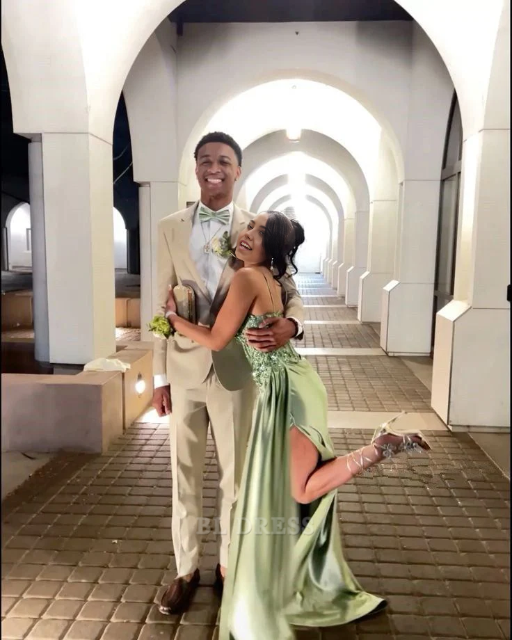 Back view of a model in a green mermaid sweetheart long formal dress with a split.